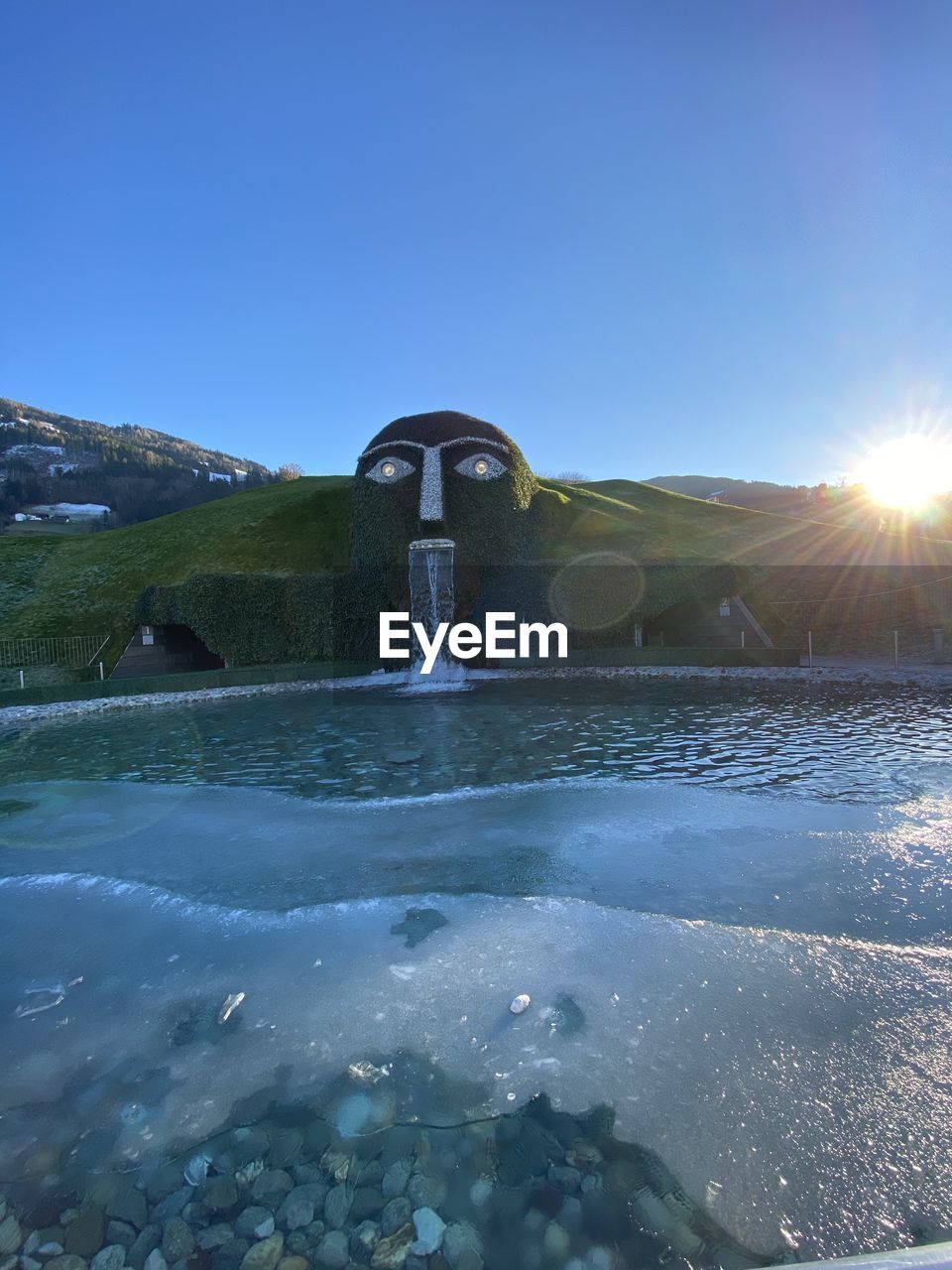 SCENIC VIEW OF WATERFALL AGAINST CLEAR SKY