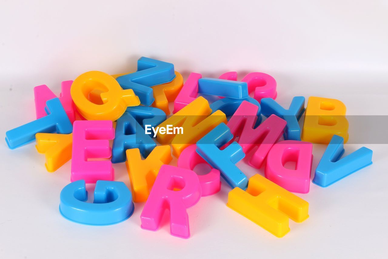 Close-up of colorful alphabets over white background