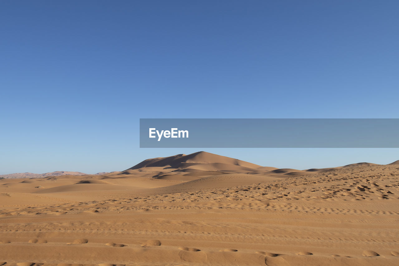 VIEW OF DESERT AGAINST CLEAR BLUE SKY