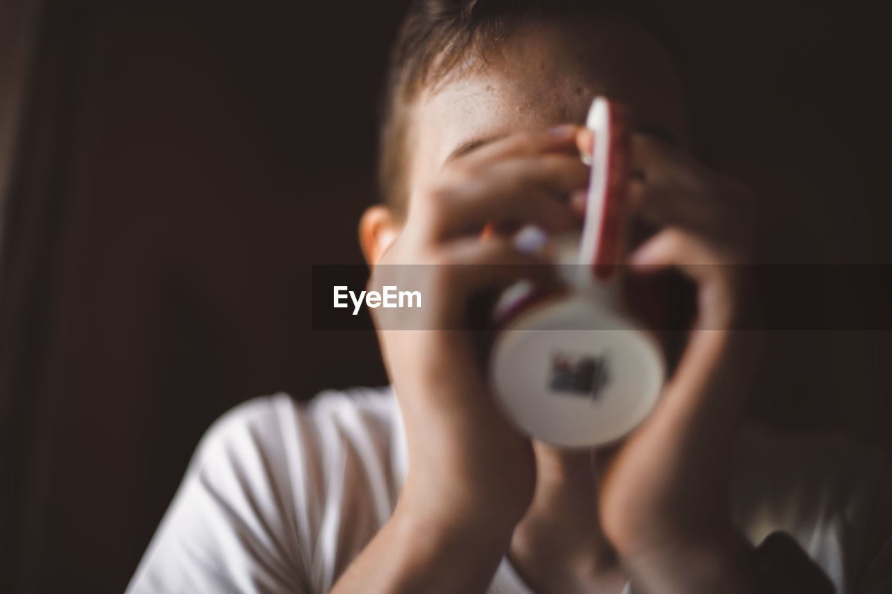 Portrait of boy holding camera