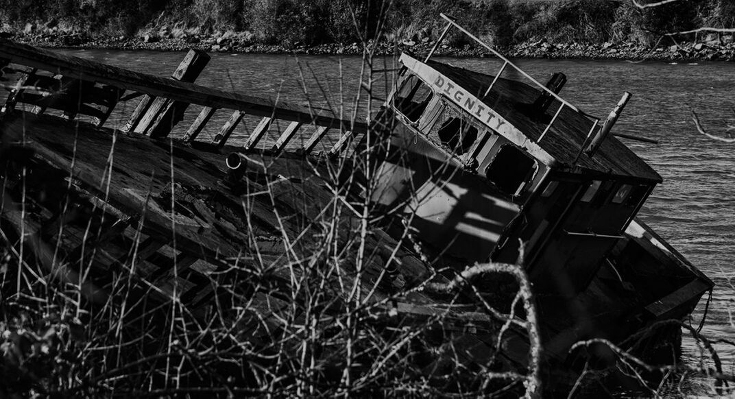 Abandoned boat at lakeshore