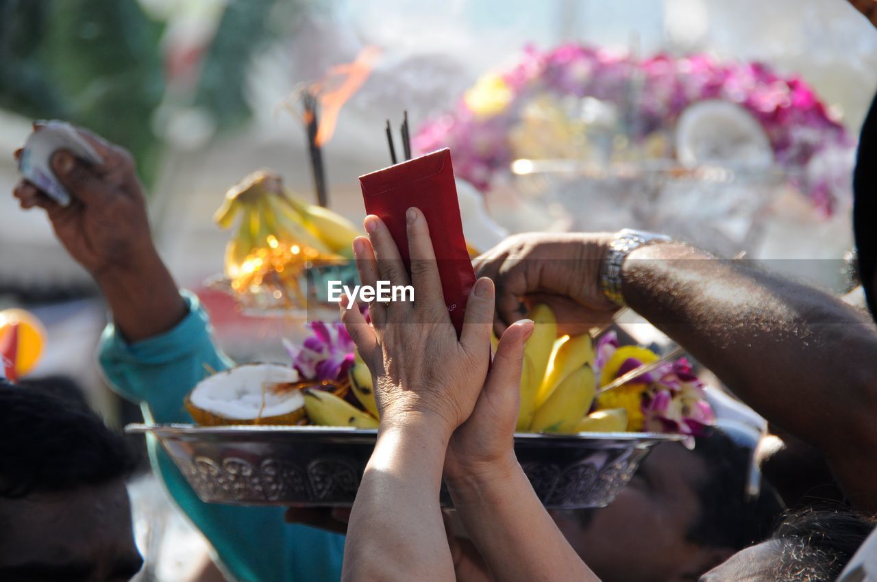 People with religious offerings at temple