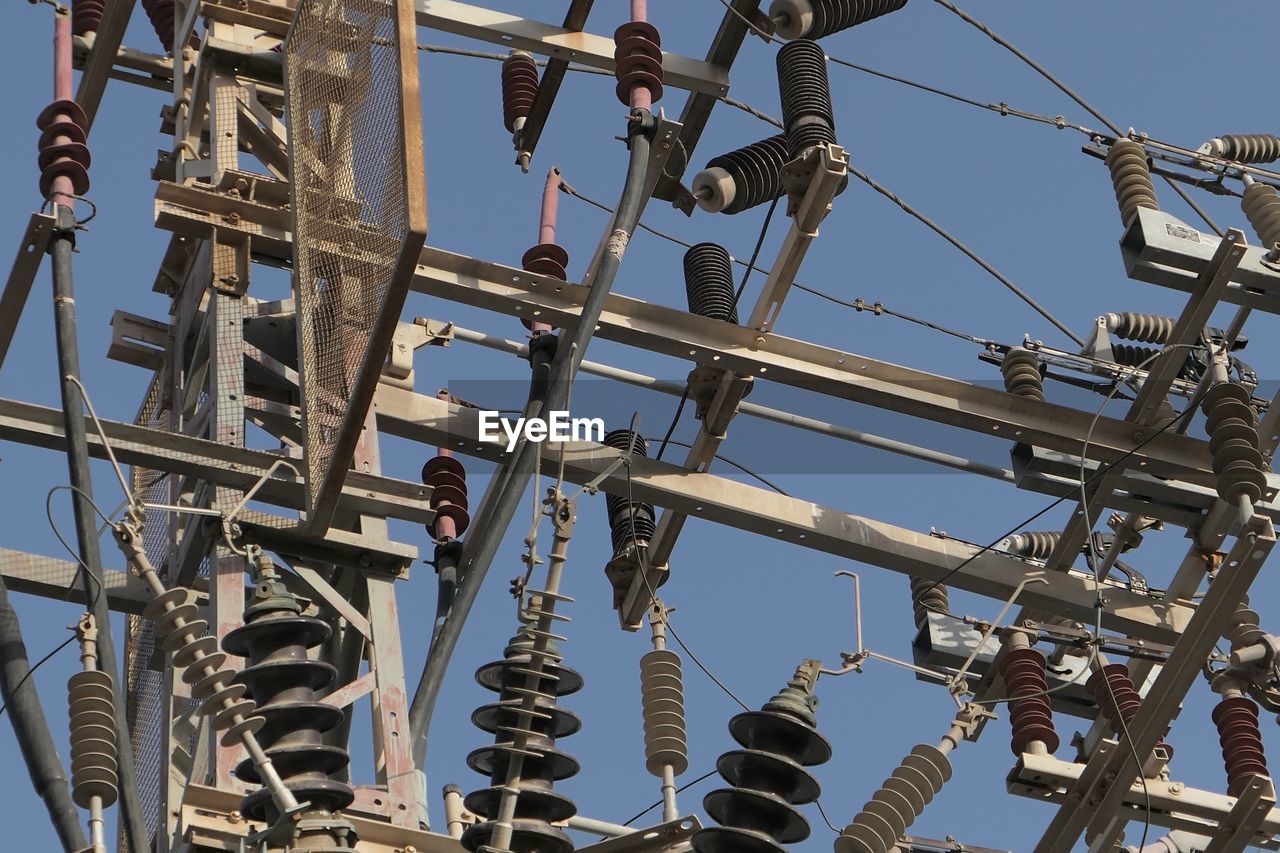 Low angle view of transformer against clear sky