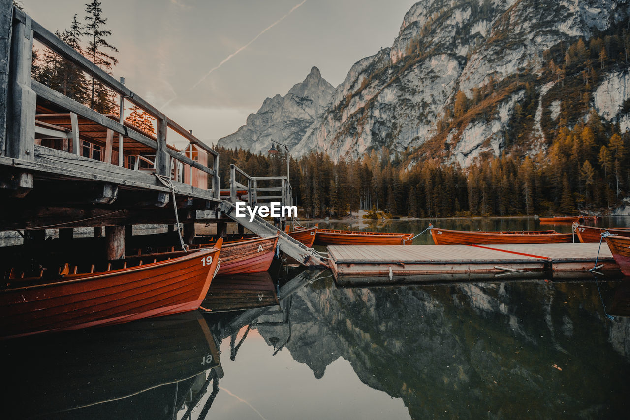 Scenic view of lake by mountains against sky