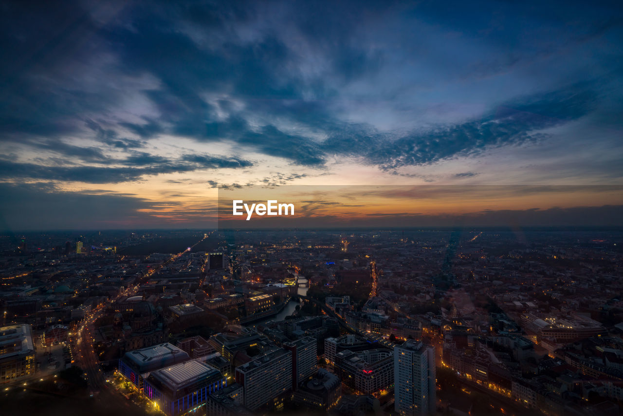 High angle view of illuminated city against sky at dusk