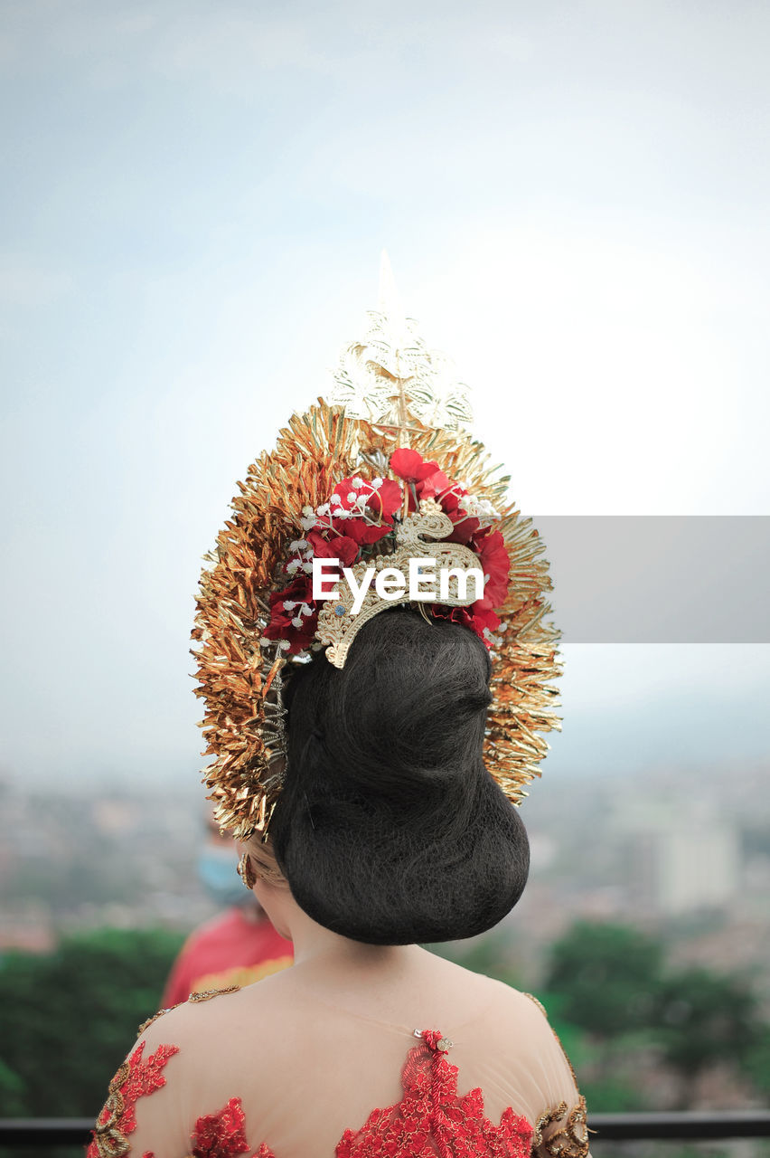 Rear view of woman looking against sky with javanese traditional clothes from indonesia