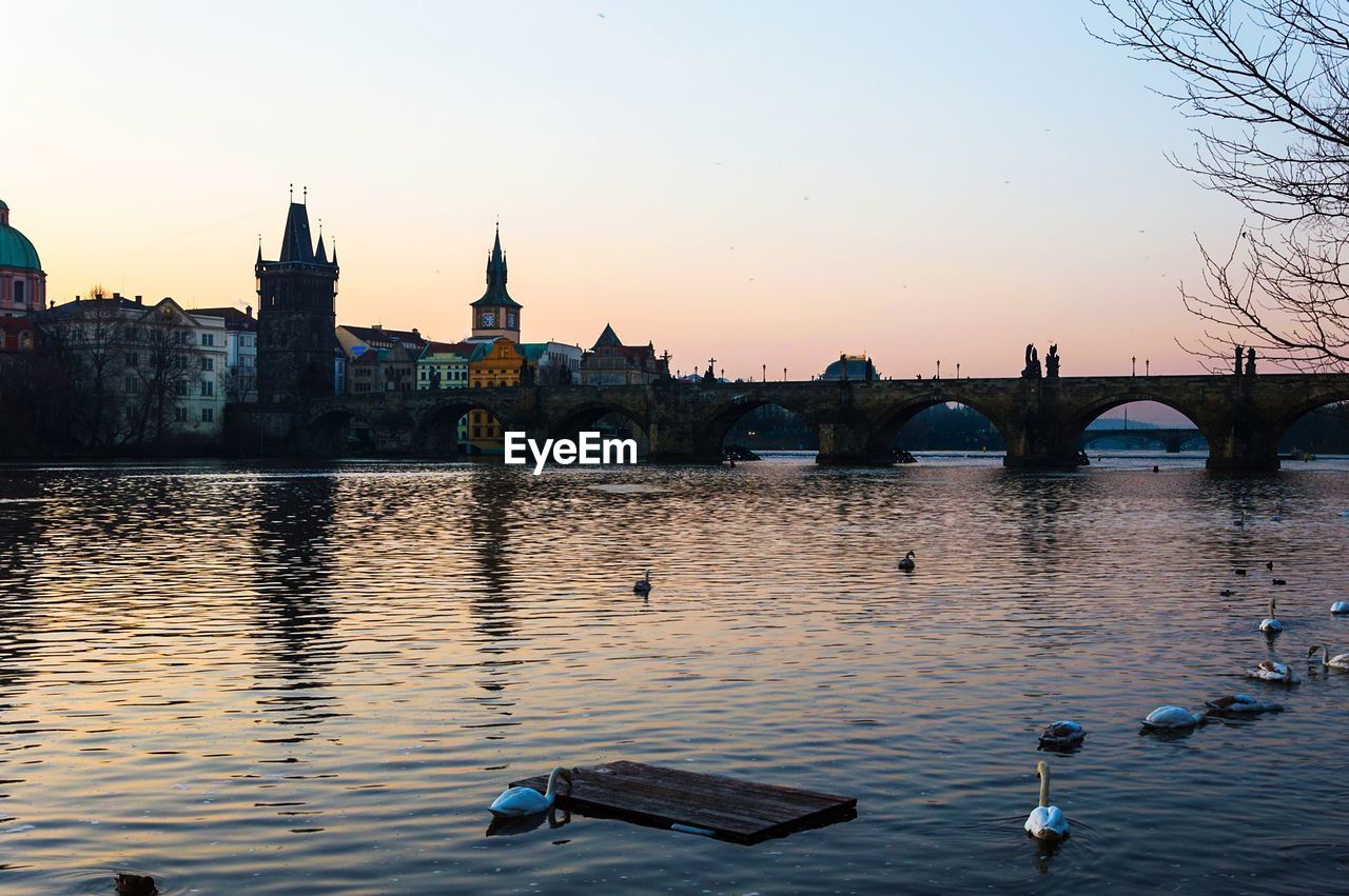 BOATS IN RIVER AT SUNSET