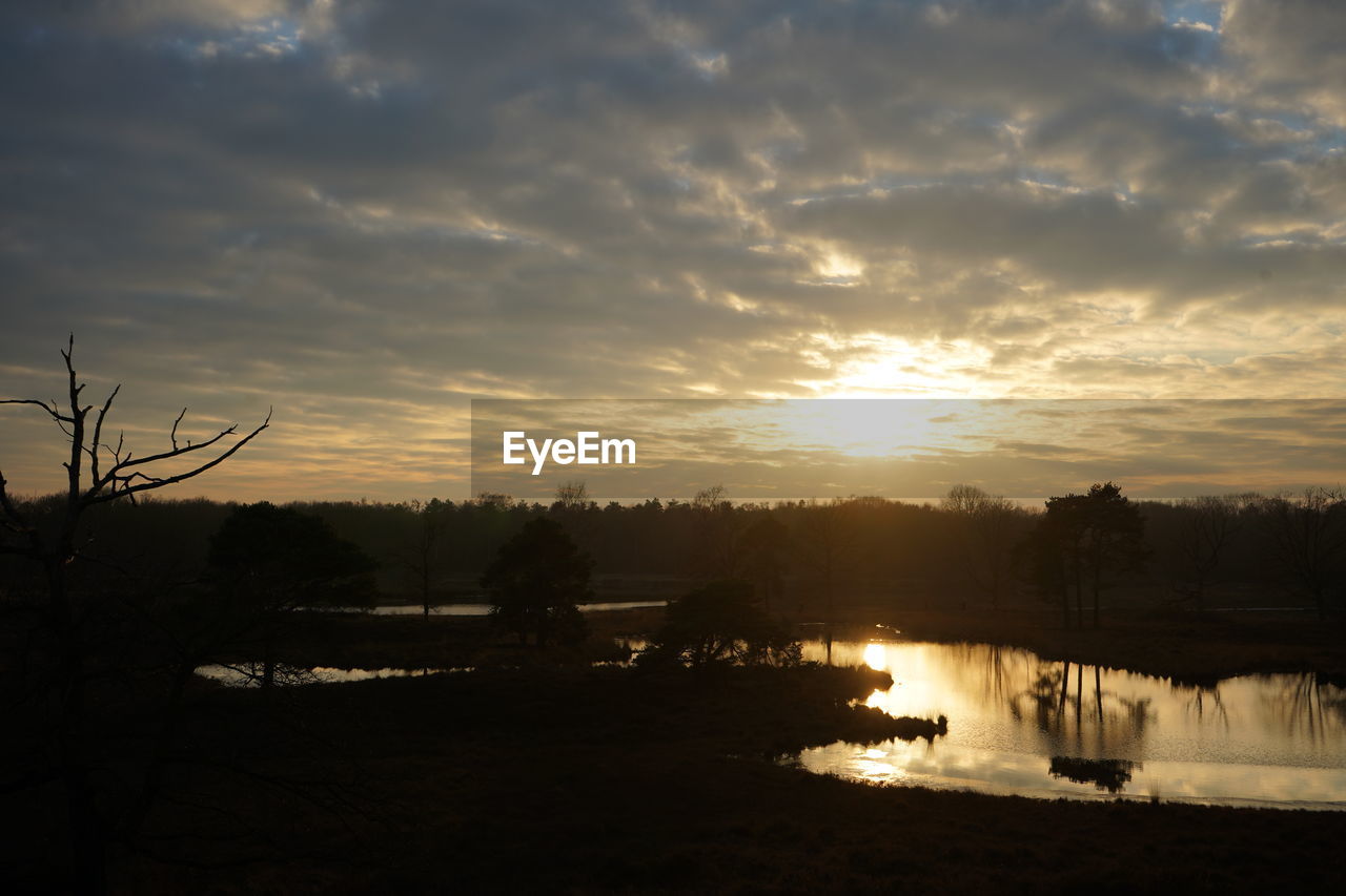 SCENIC VIEW OF LAKE AGAINST ORANGE SKY