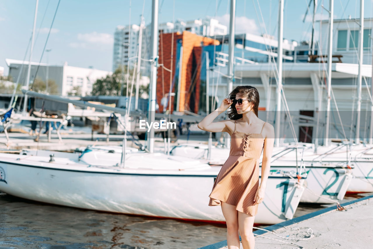 Young woman on sailboat at harbor
