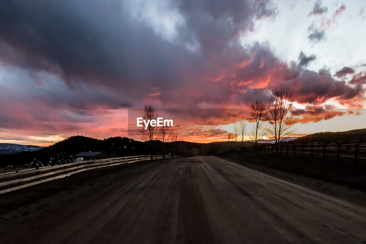 VIEW OF ROAD AGAINST CLOUDY SKY