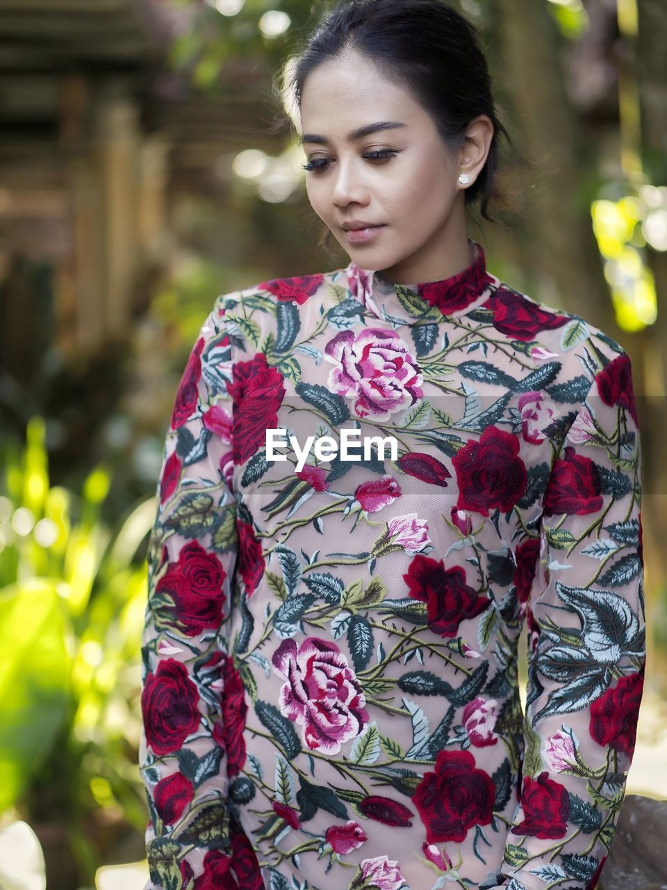 Portrait of young woman standing outdoors