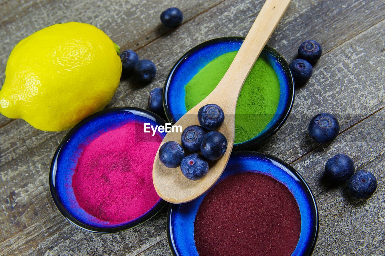 HIGH ANGLE VIEW OF MULTI COLORED CANDIES ON TABLE