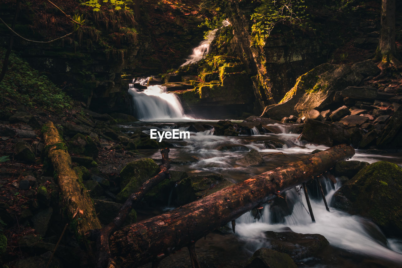 Satiny waterfalls. breathtaking, untouched nature around the water flowing down cascades 