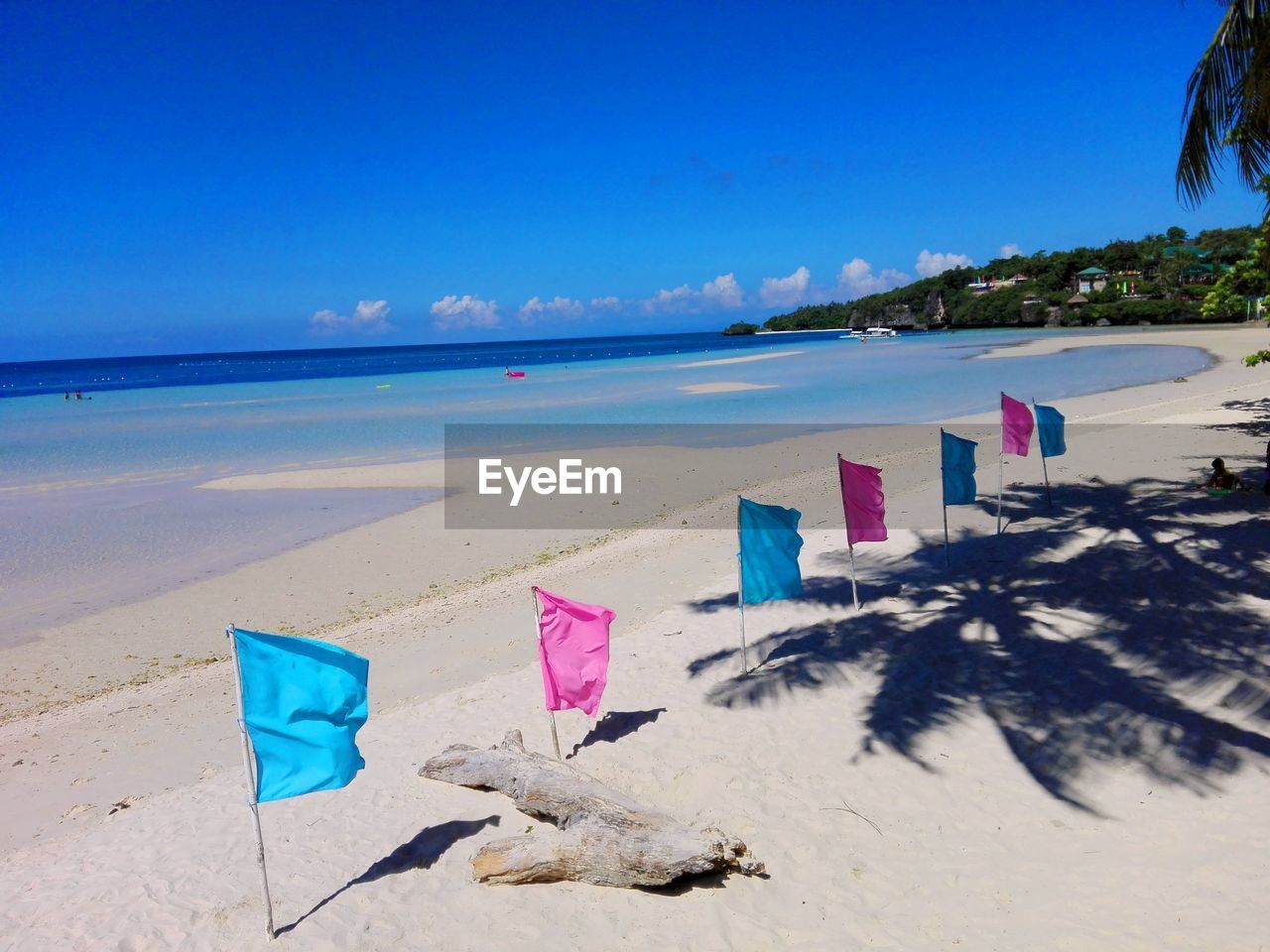 DECK CHAIRS ON BEACH AGAINST SKY