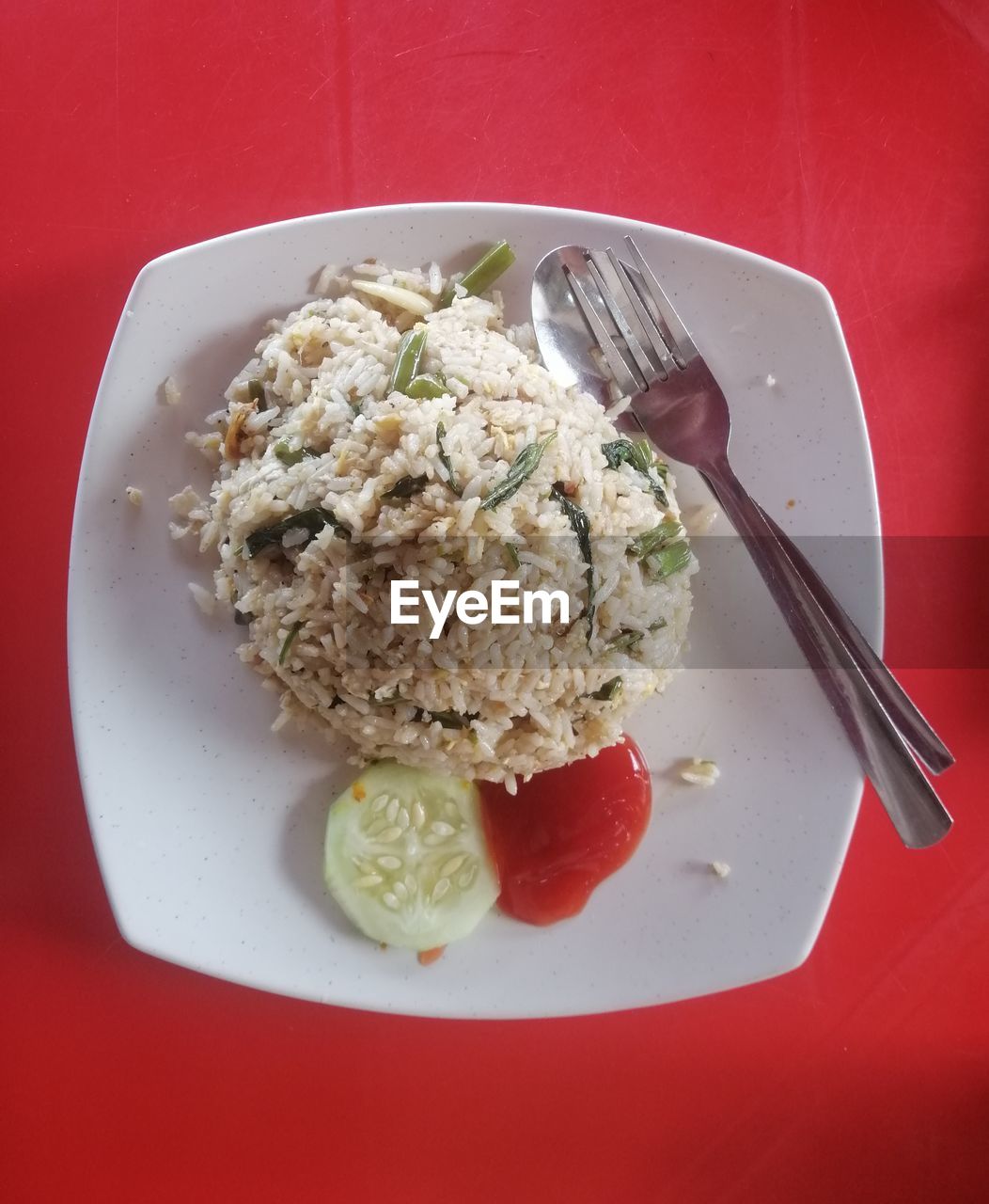 High angle view of malay cuisine fried rice called 'nasi goreng kampung' served in white plate