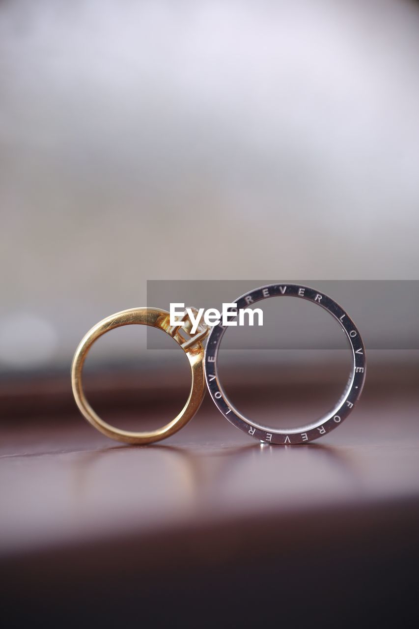 Close-up of wedding rings on table