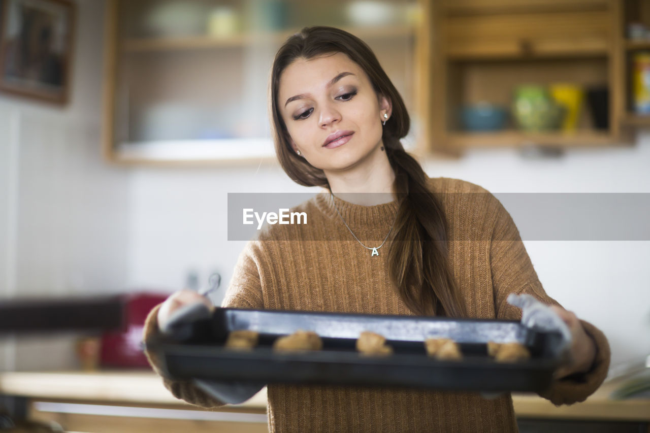 Young woman baking cookies in the kitchen