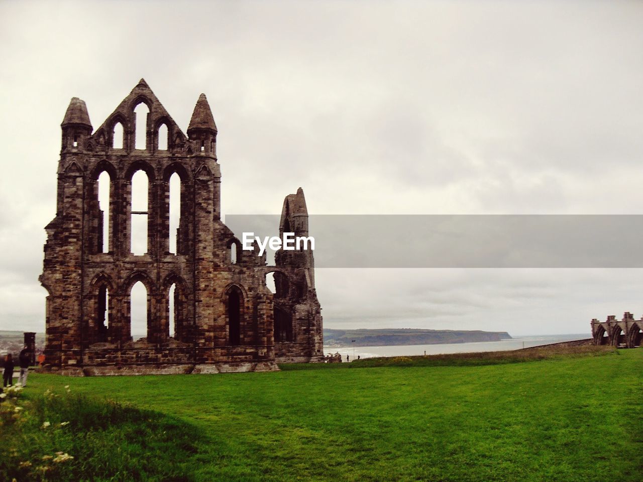 Ruins of building against cloudy sky