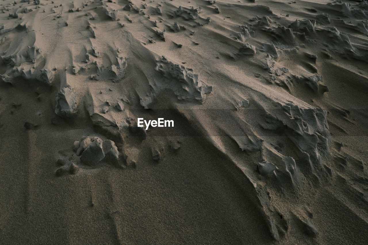 High angle view of footprints on sand at beach