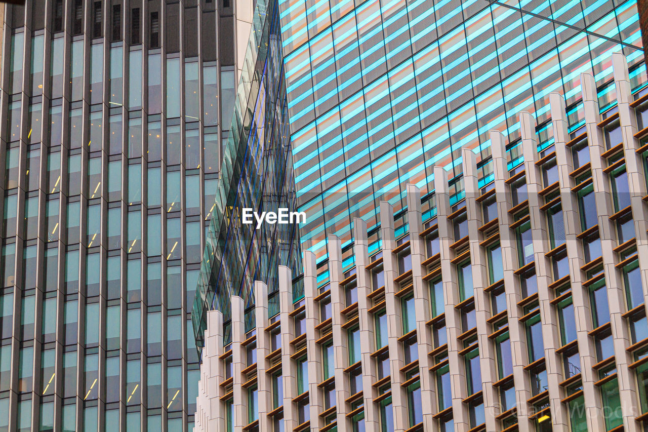 Low angle view of modern glass buildings in city