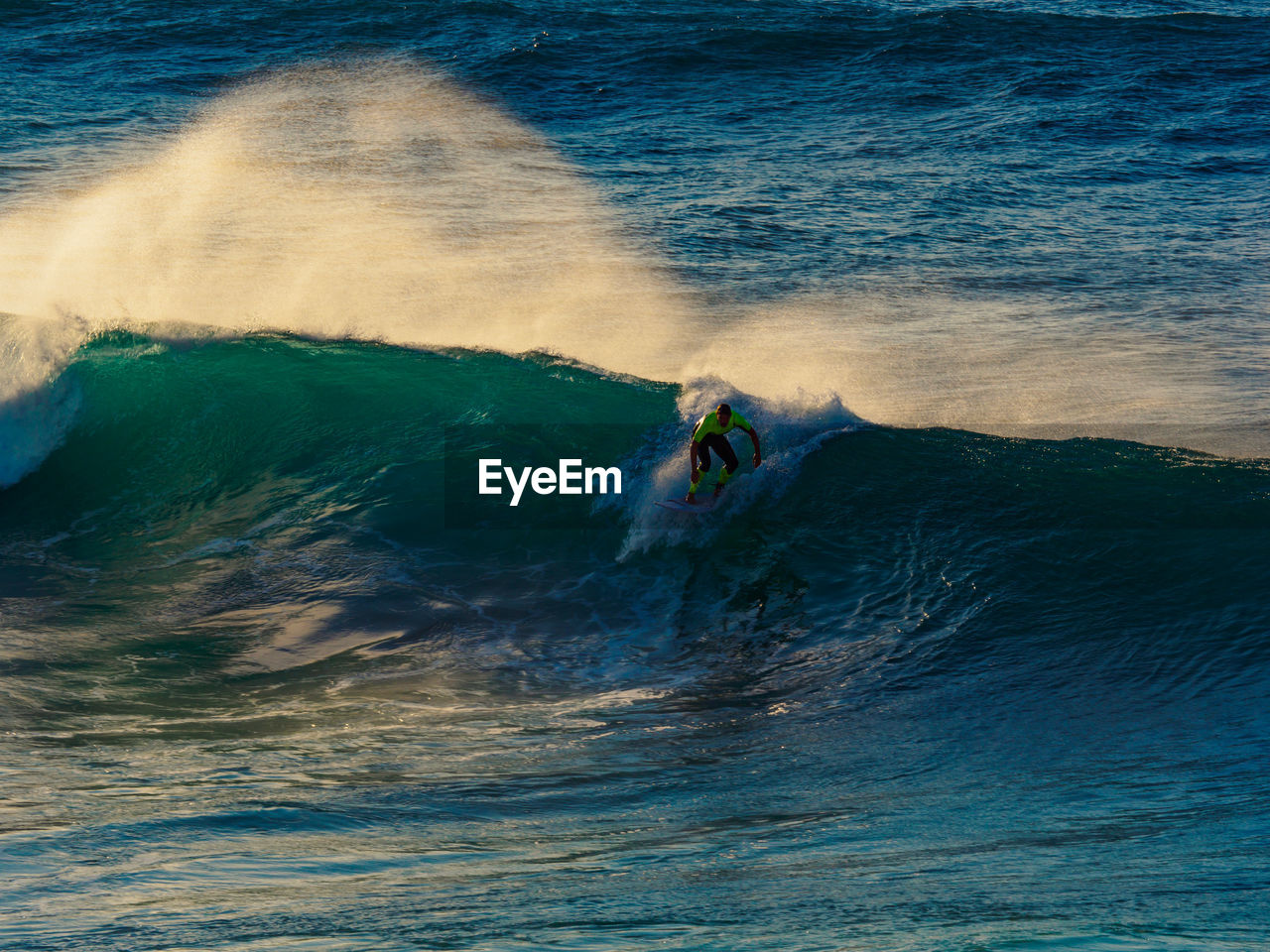 Person surfing on waves at sea