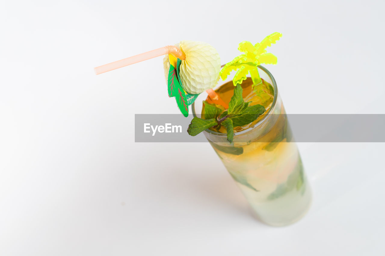 Close-up of drink on glass against white background