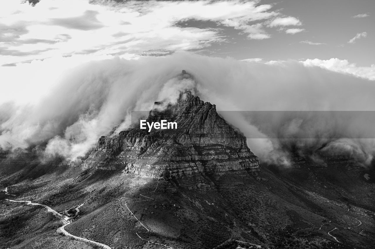 Iconic table mountain with tablecloth clouds as seen from lion's head in cape town, south africa