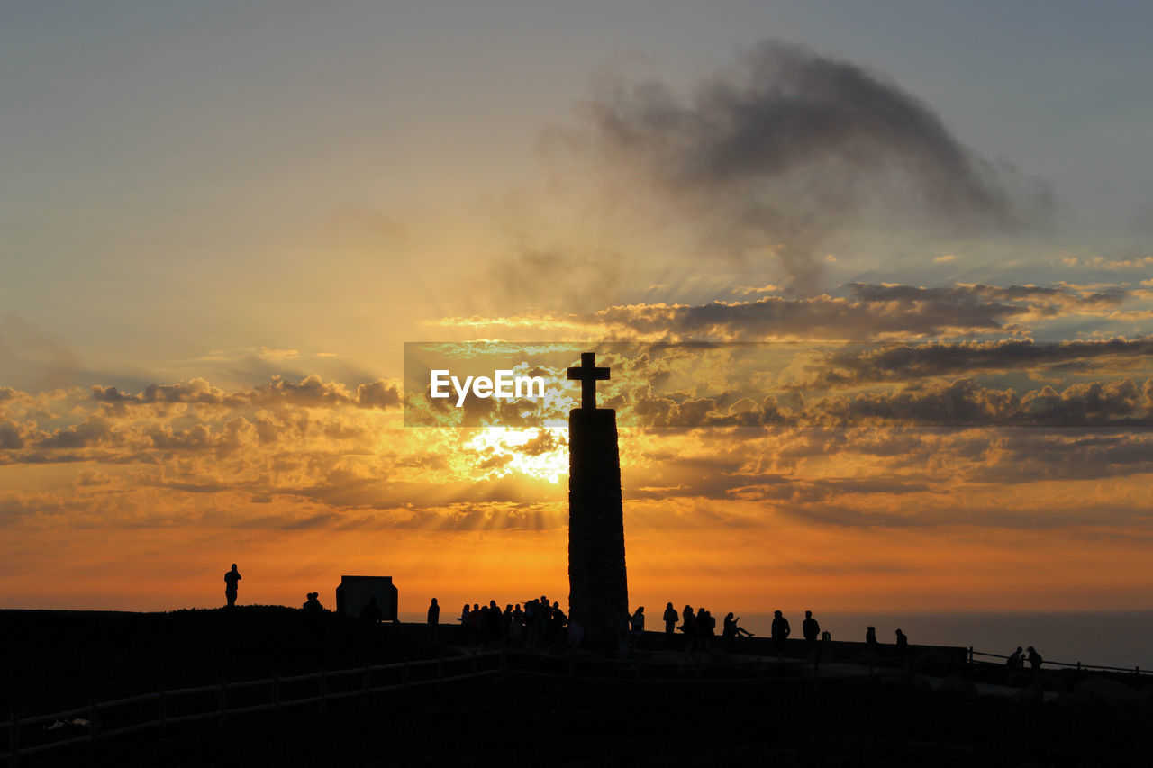 Silhouette of people at sunset