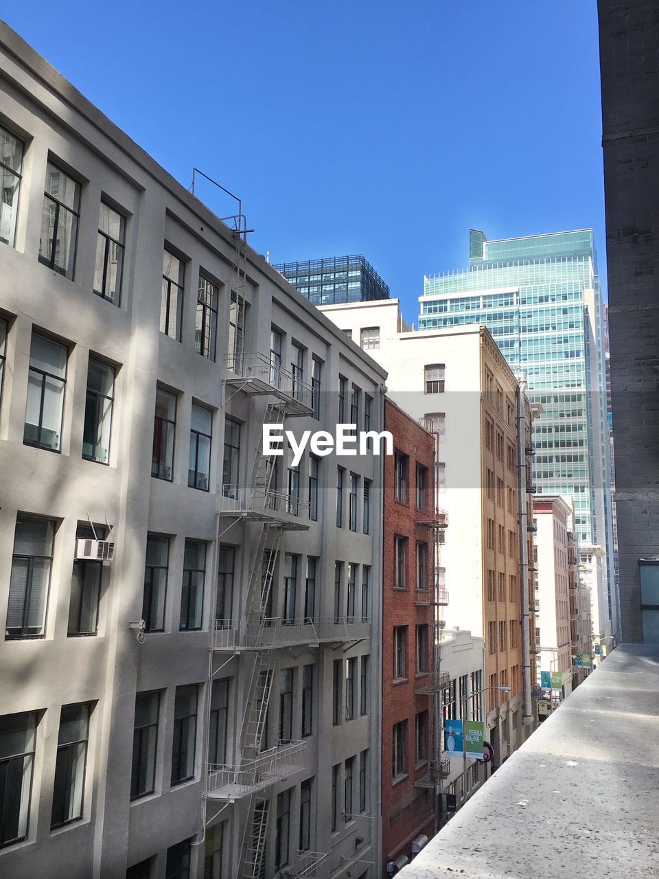 Buildings in city against clear sky