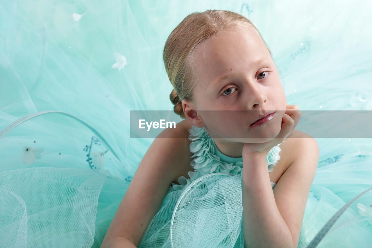 Portrait of cute girl wearing turquoise dress