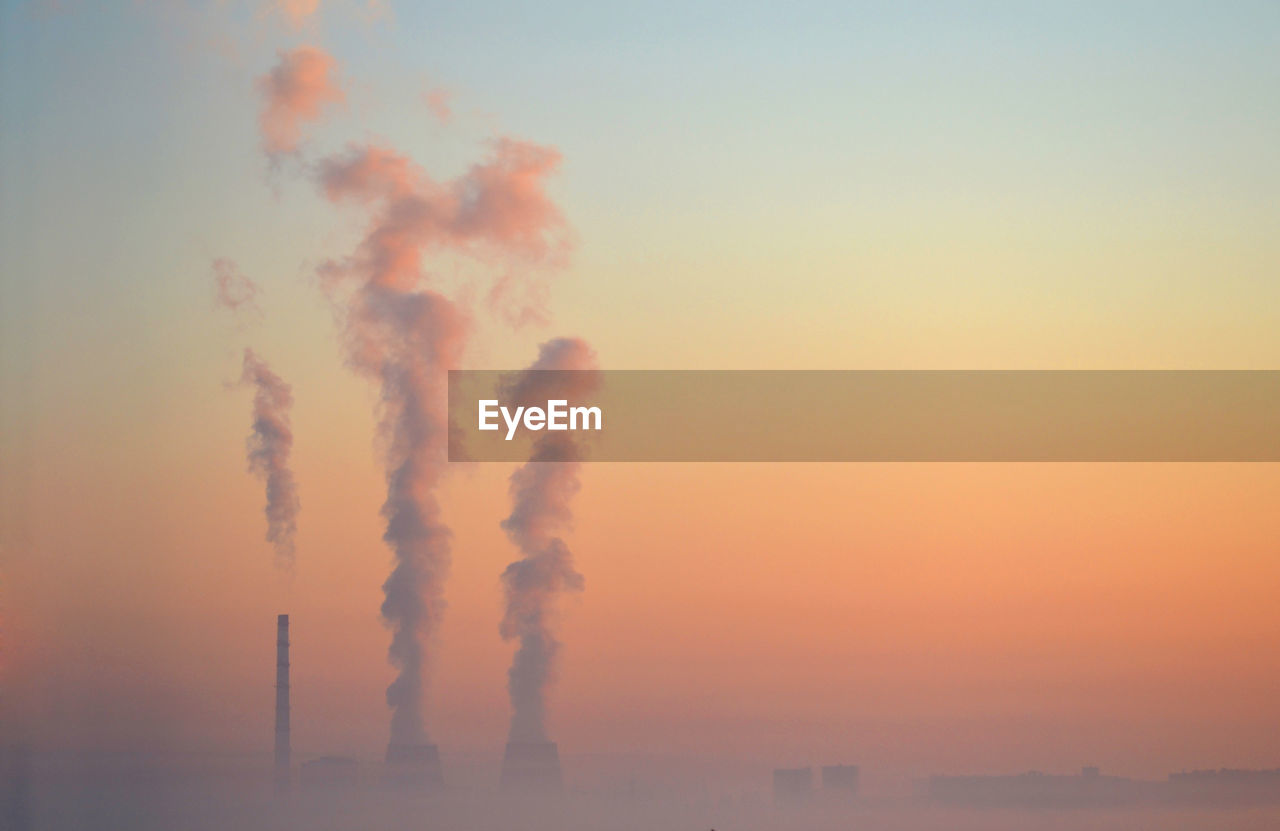 SMOKE EMITTING FROM CHIMNEY AT SUNSET