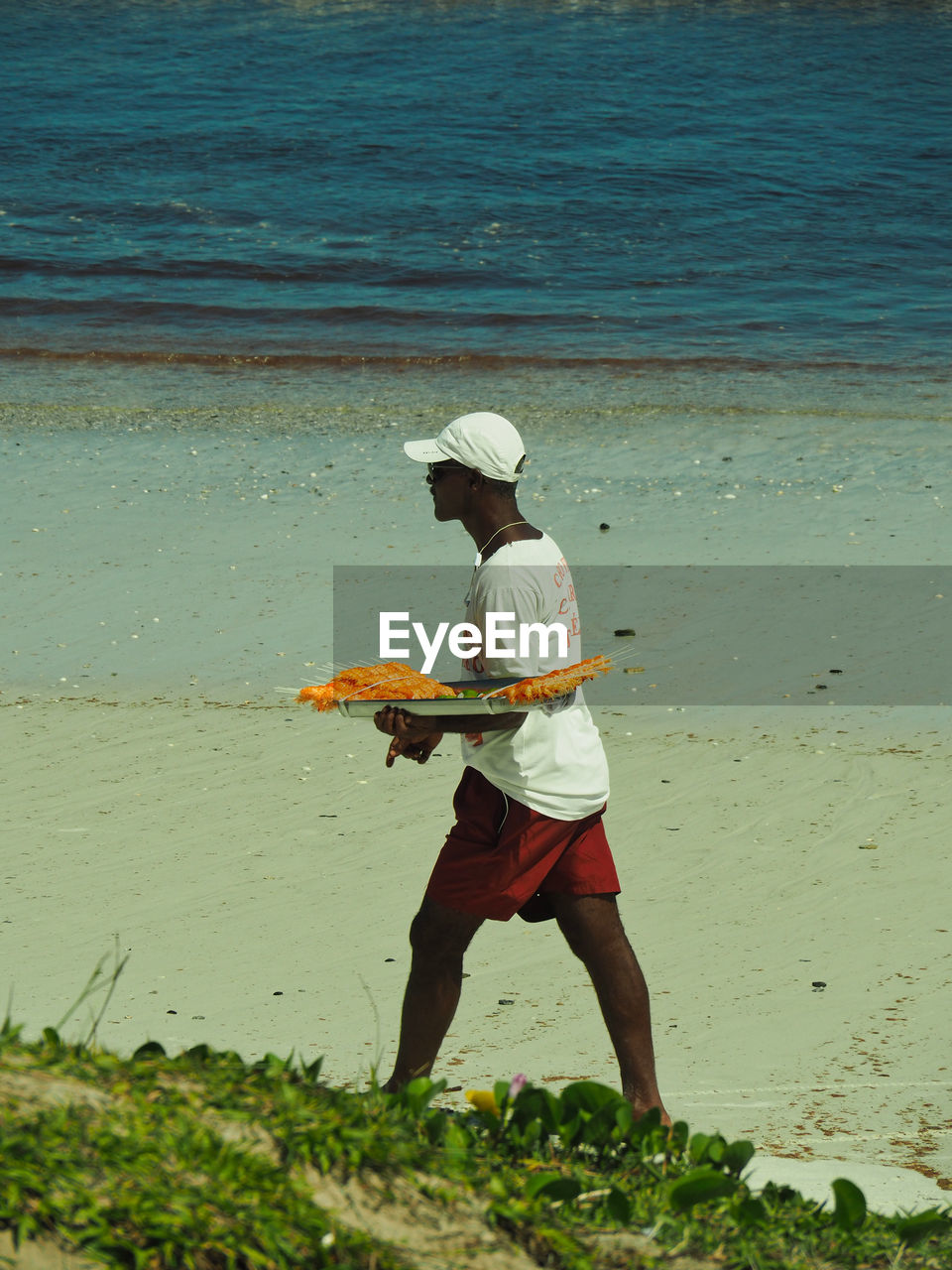 MAN STANDING ON BEACH