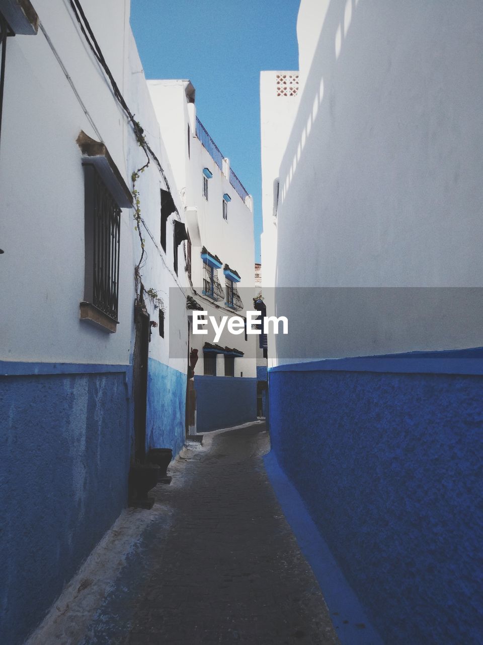 Empty alley amidst buildings in city