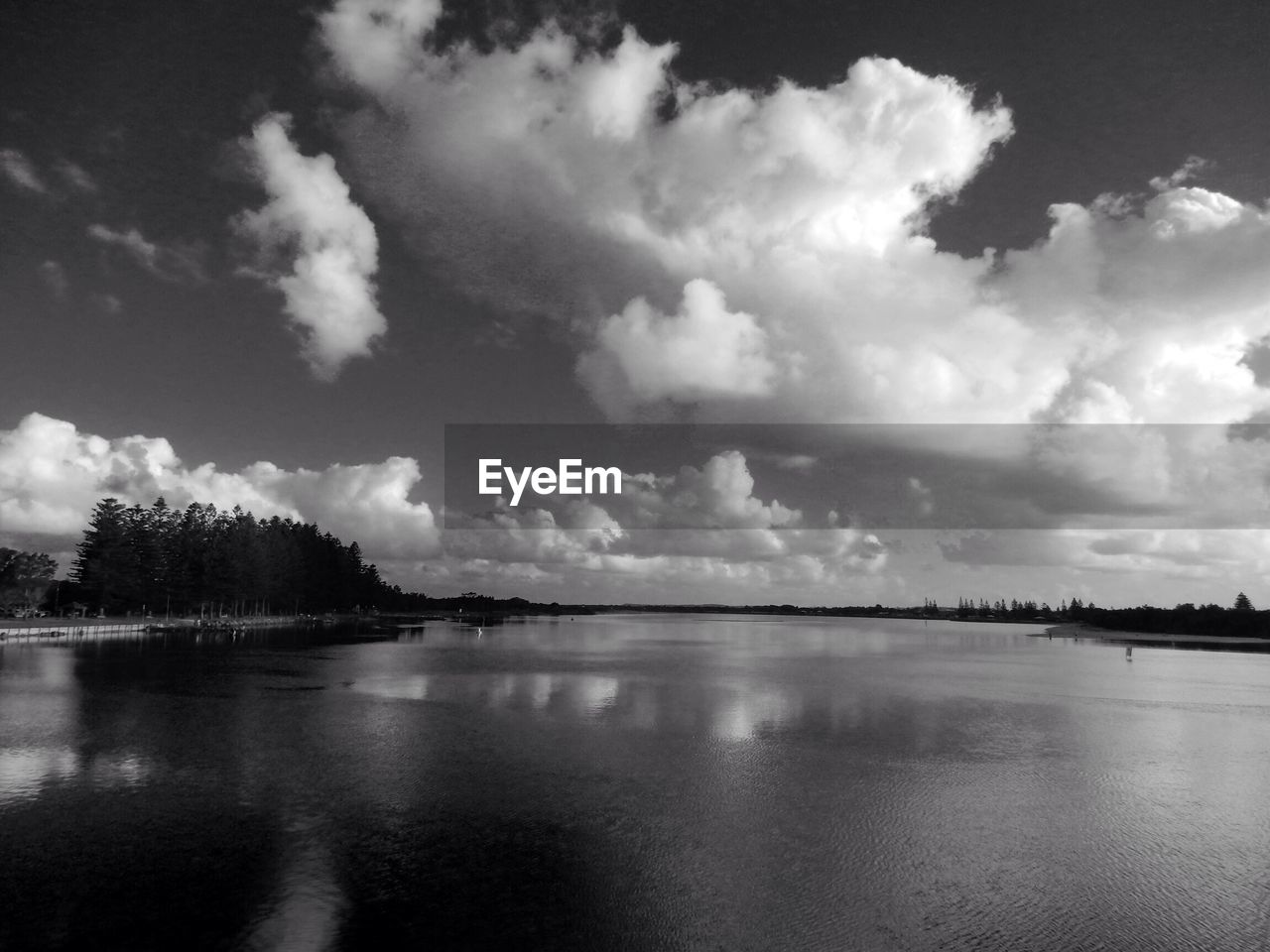 Scenic view of lake against cloudy sky