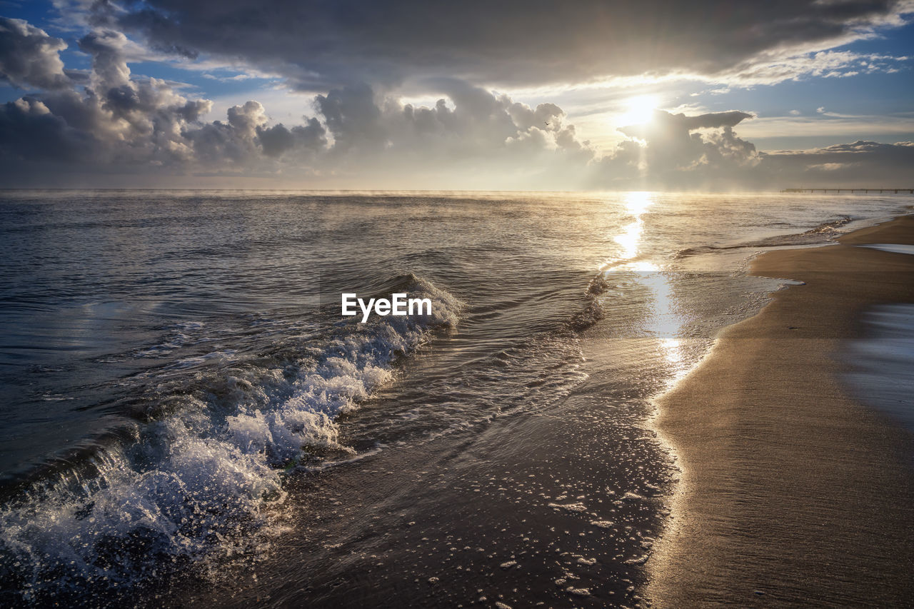 Sun over beach on baltic sea