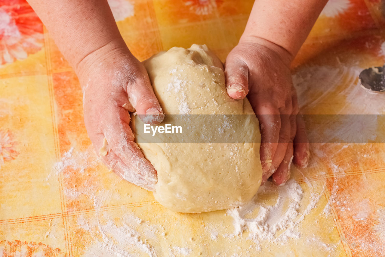 cropped hand of person holding dough