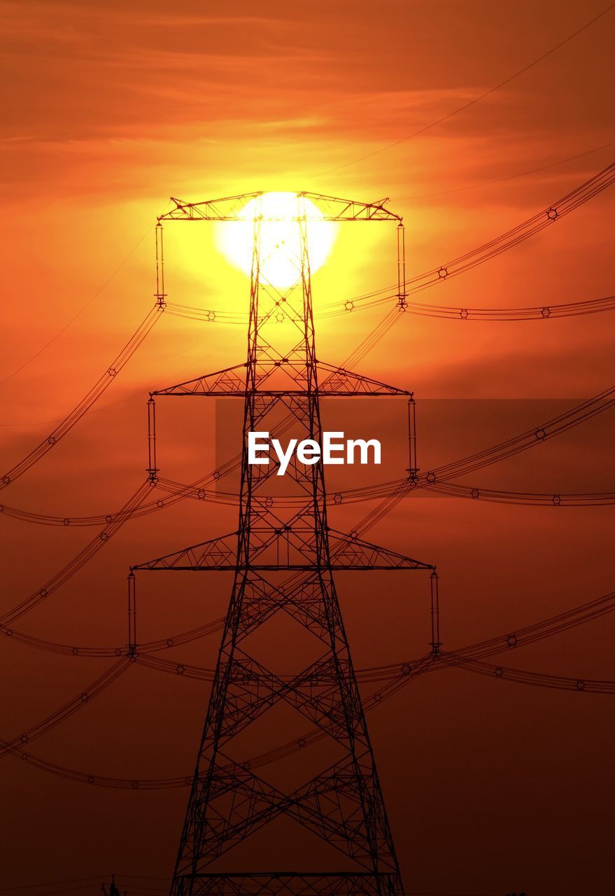 LOW ANGLE VIEW OF SILHOUETTE ELECTRICITY PYLON DURING SUNSET