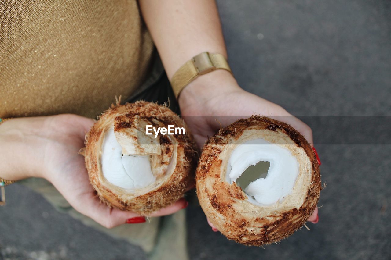 Close-up of woman holding coconuts