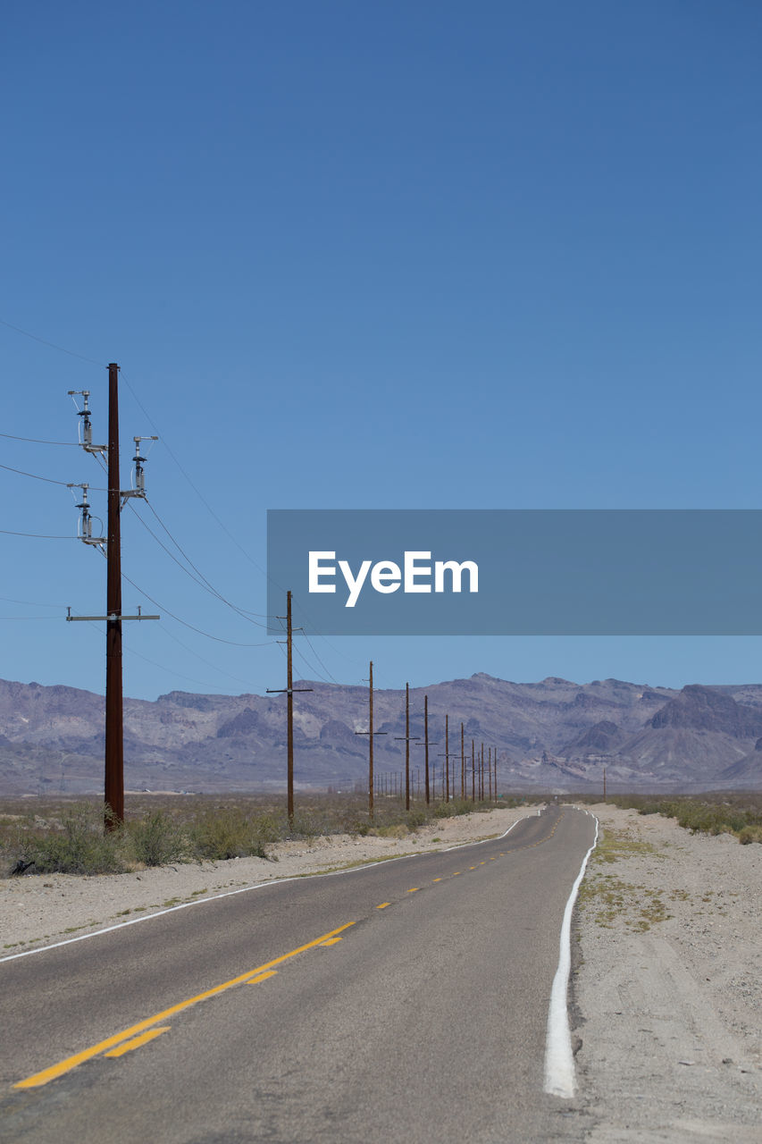 Road by mountain against clear sky