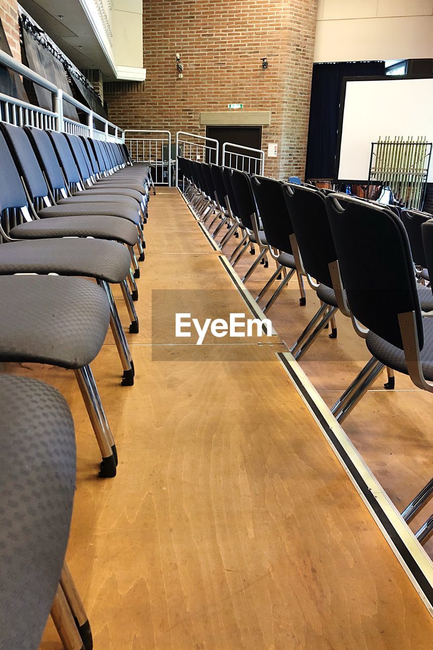 EMPTY CHAIRS AND TABLES IN ROW