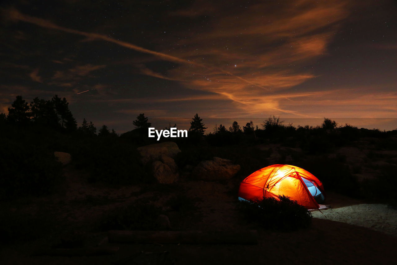 Illuminated tent at under bright night sky