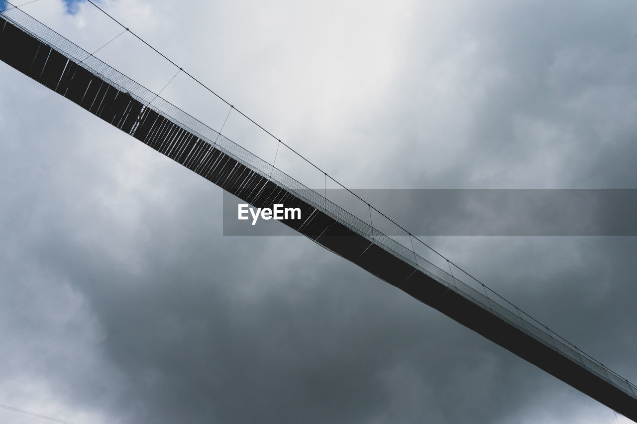 LOW ANGLE VIEW OF BRIDGE AGAINST SKY DURING SUNSET