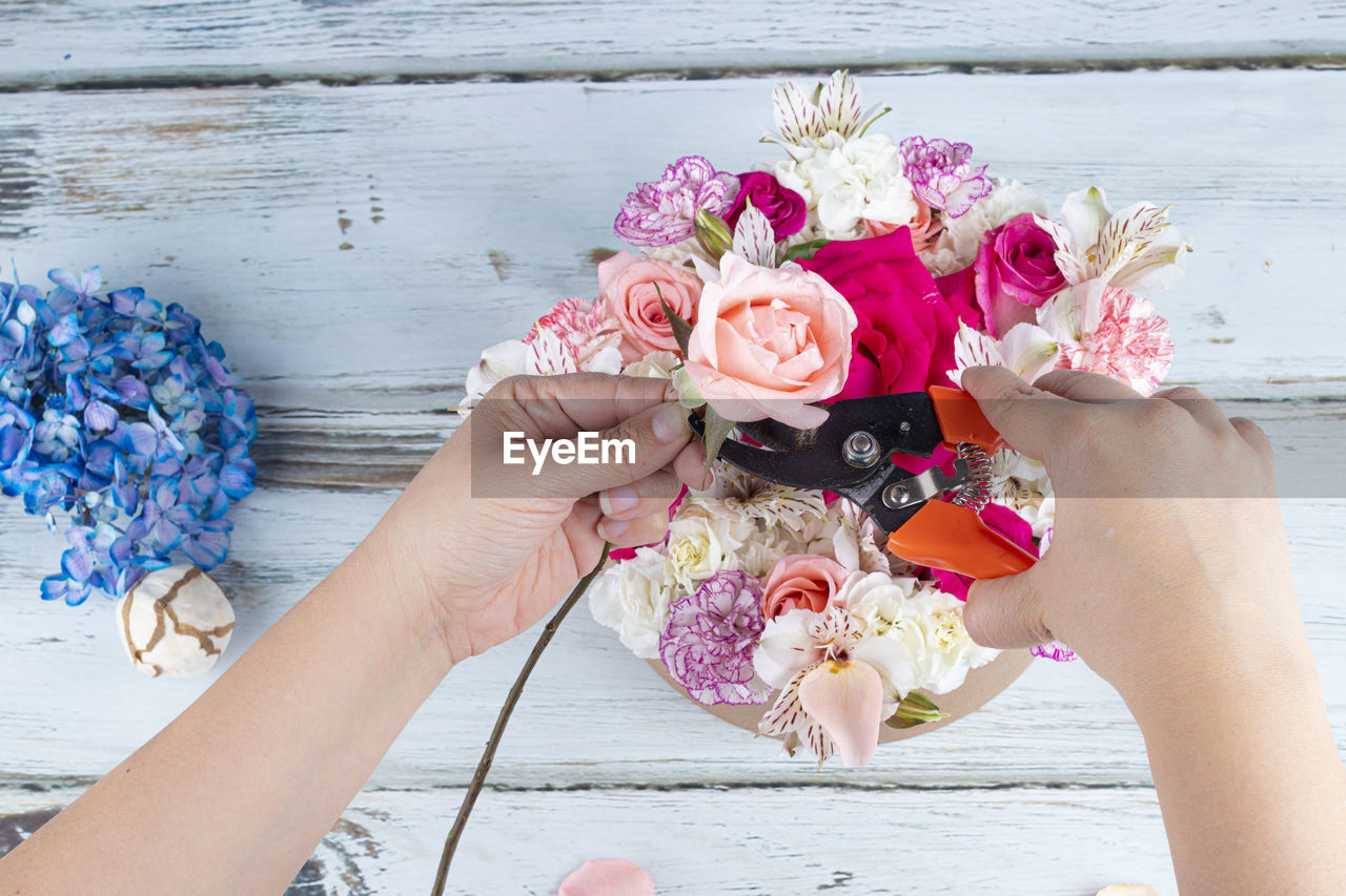 Midsection of woman holding flower bouquet