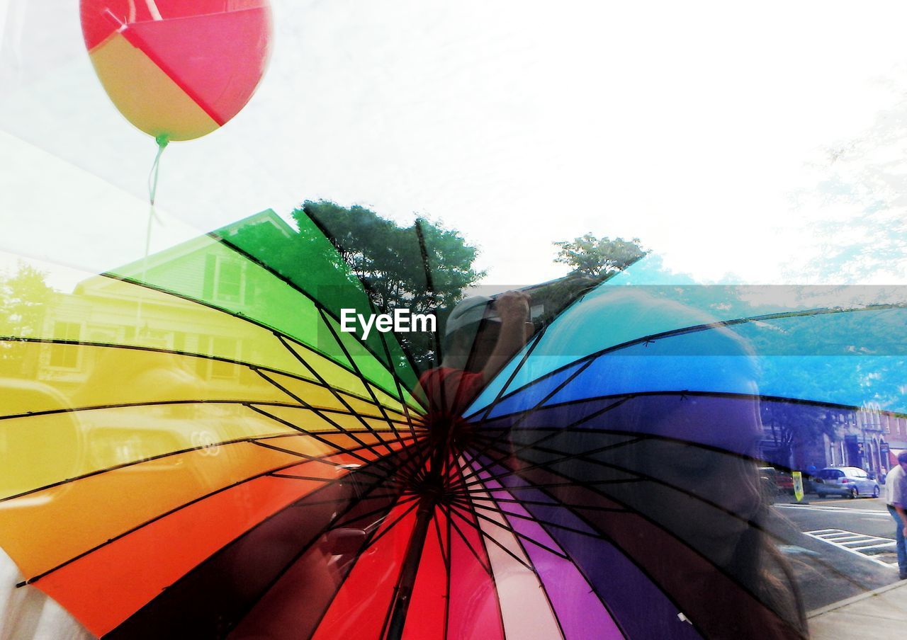 LOW ANGLE VIEW OF UMBRELLAS