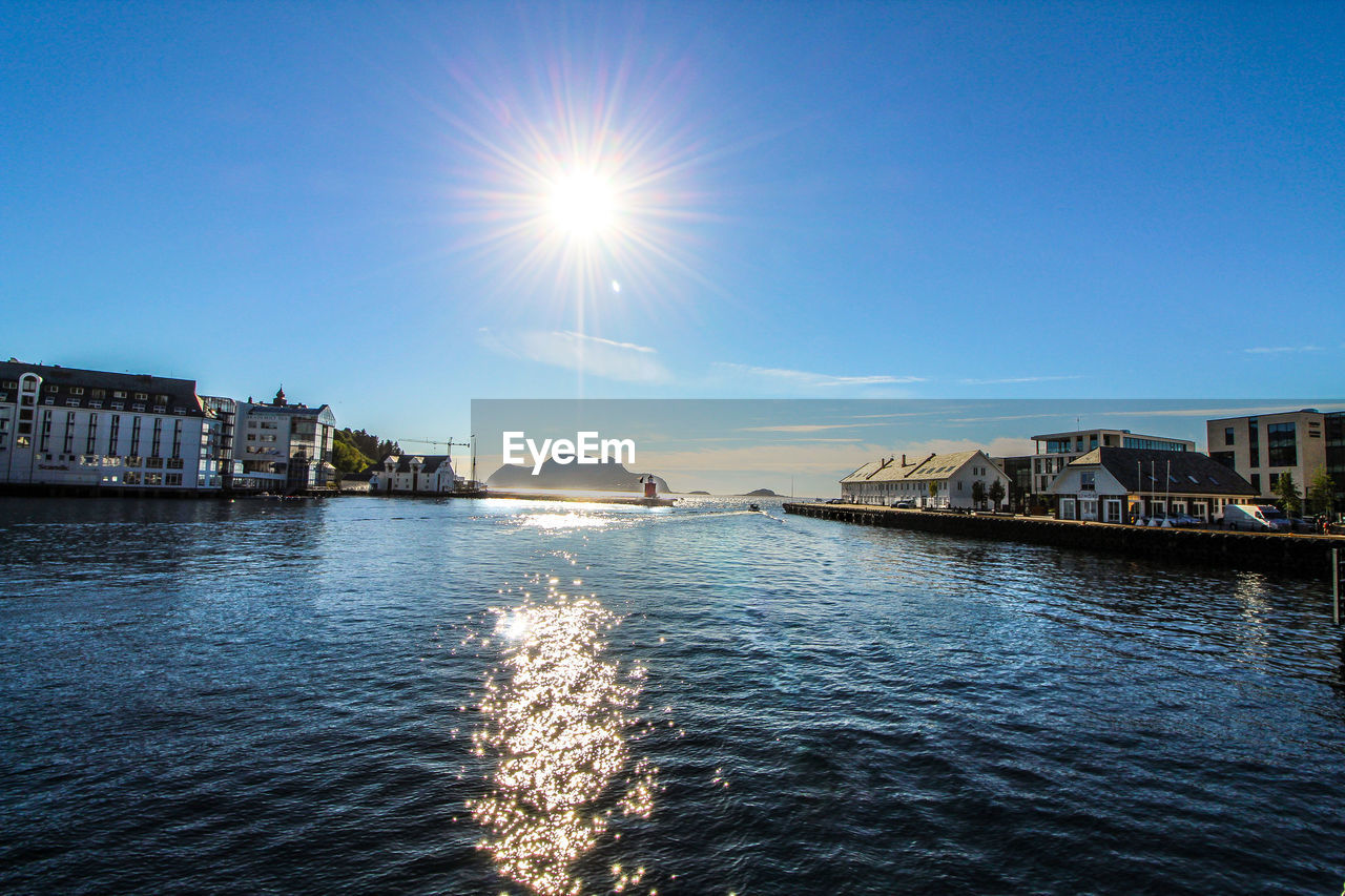 SCENIC VIEW OF RIVER AGAINST BUILDINGS IN CITY AGAINST SKY