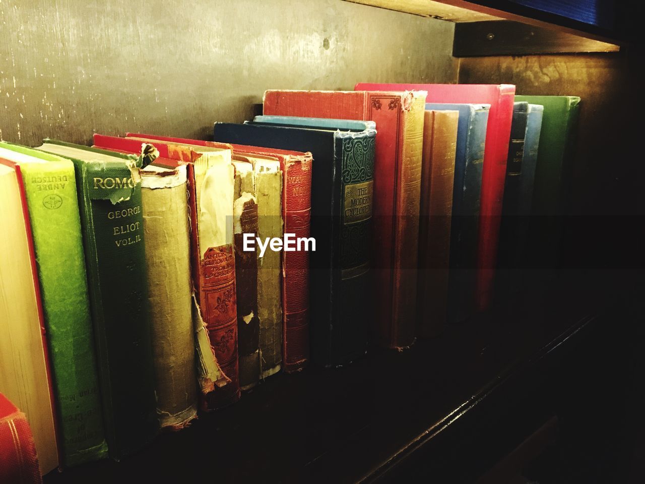 Close-up of old books arranged on shelf