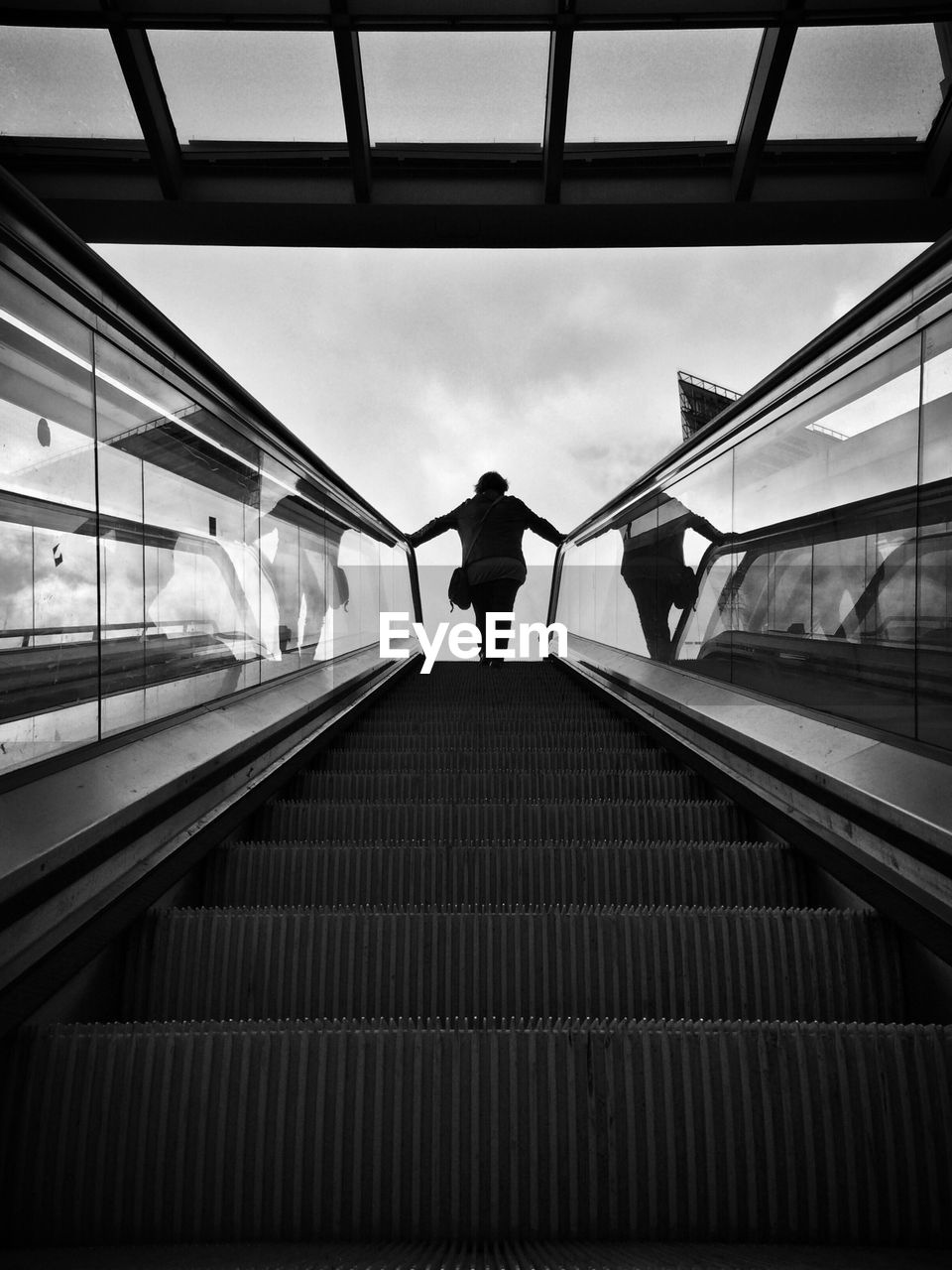 Low angle view of person on escalator