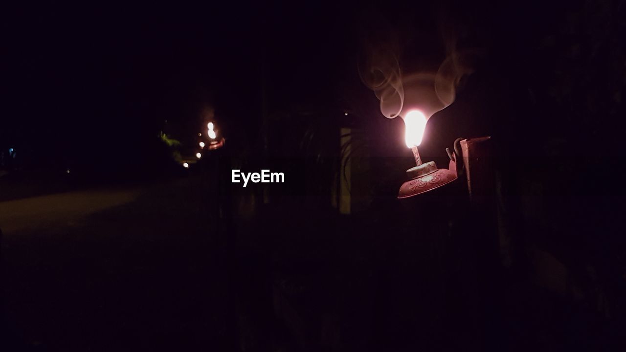 CLOSE-UP OF FIRE BURNING IN DARK