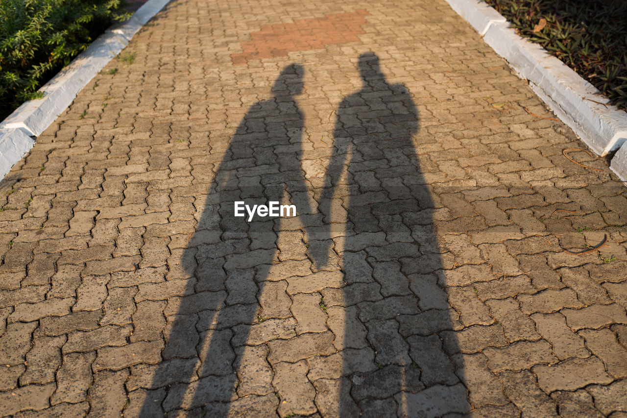 High angle view of people shadow on street