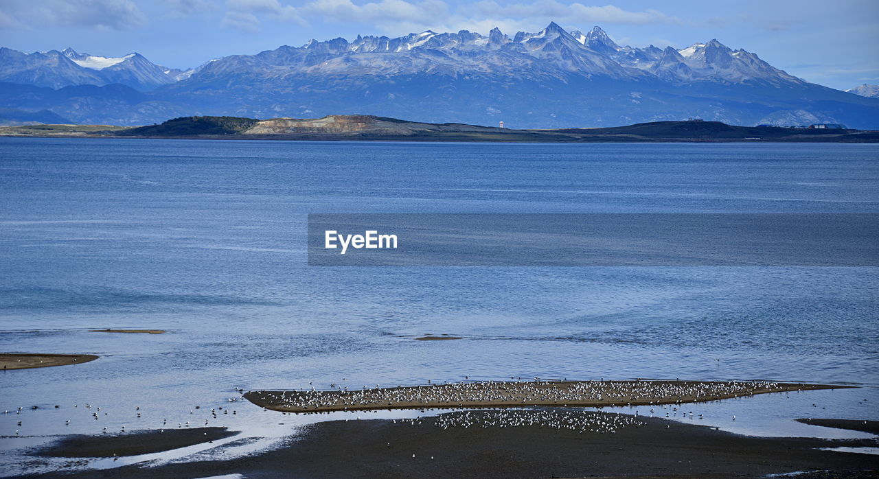 SCENIC VIEW OF LAKE BY MOUNTAINS AGAINST SKY